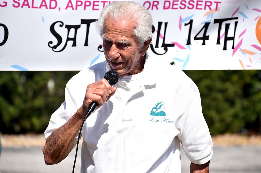 John Balerna, a longtime resident of Twin Shores, shares her story with the crowd.
