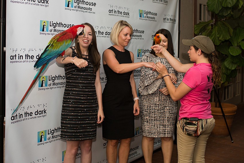 Nicole Mobley, Chelsa Altena and Olga Strelkov take a photo with the birds from the Sarasota Jungle Gardens.