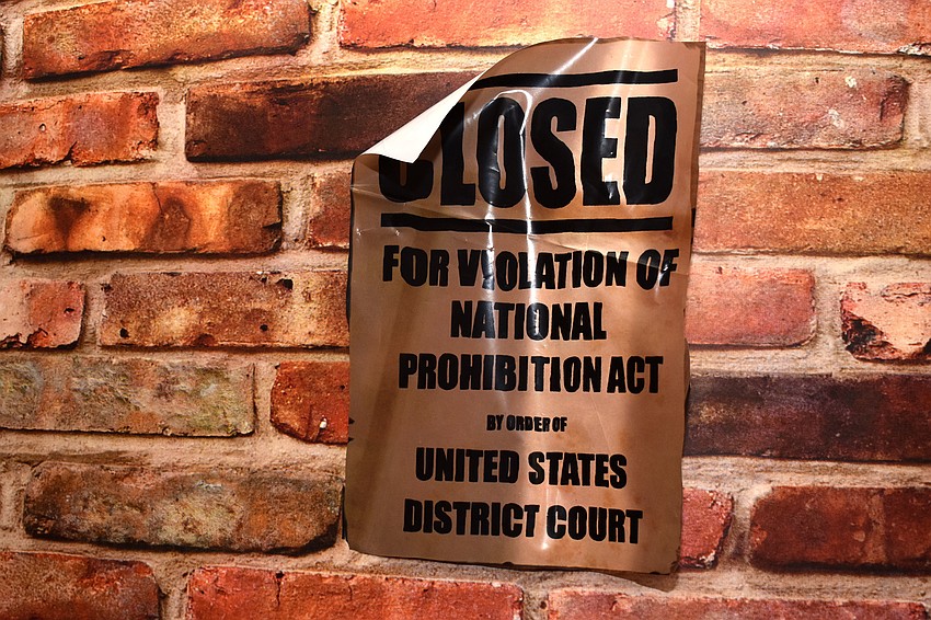 Signs outside the speakeasy warned of the National Prohibition Act.