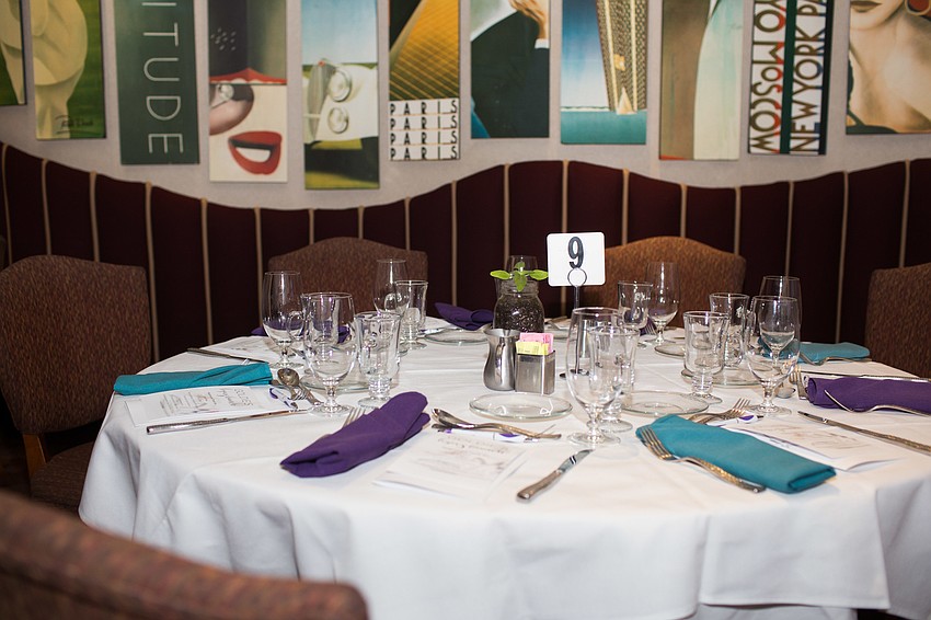 The tables were decorated with purple and teal napkins.