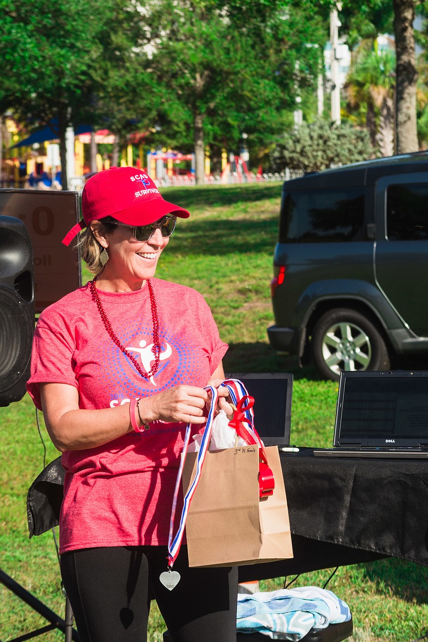 Tracee Murphy hands out awards to winners.