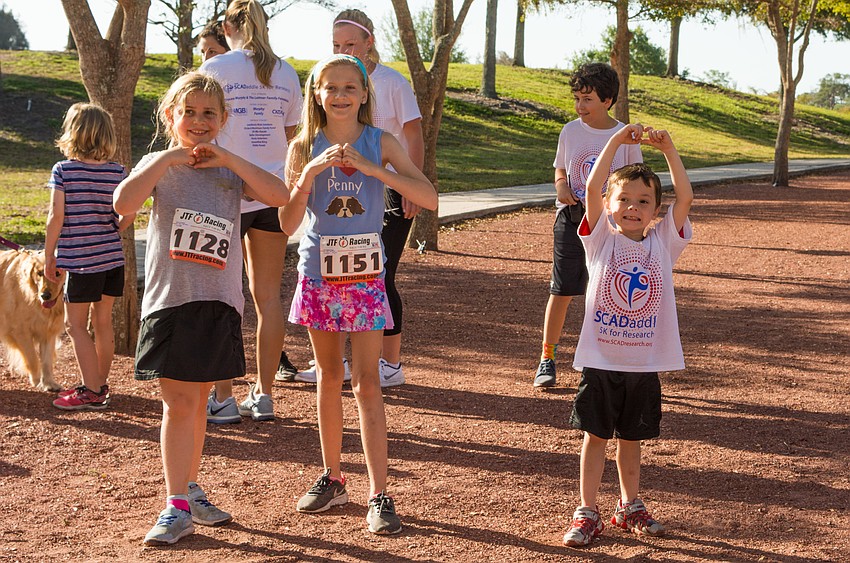 Madeline Conger, Liza Friedman and Shane Sherlock make hearts in support of SCAD survivors.