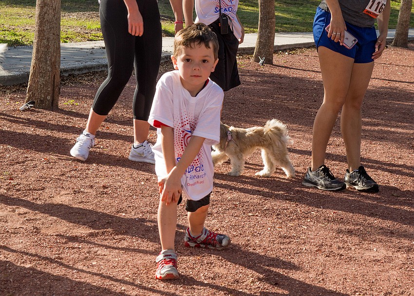 Shane Sherlock stretches before the kids fun run.