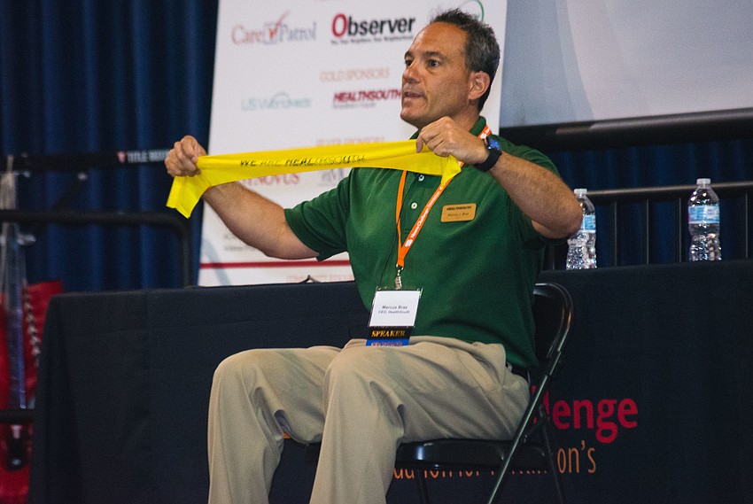 HealthSouth Rehabilitation Hospital of Sarasota 's CEO Marcus Braz demonstrates stretching exercises.