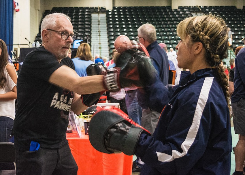 Toni Spitzer and Tiffany Frichert demonstrate boxing as a way to combat symptoms of Parkinson's.