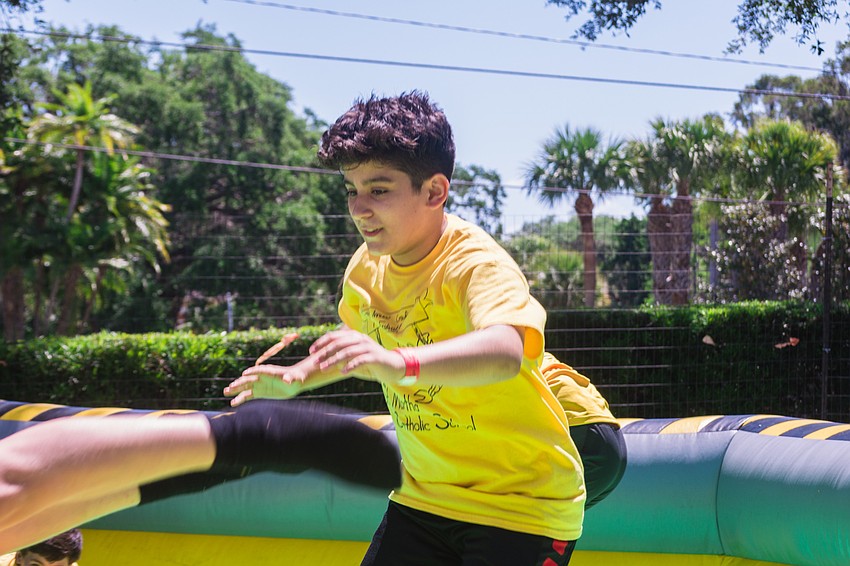 Dante Benevento tries to duck and cover in an inflatable obstacle course.