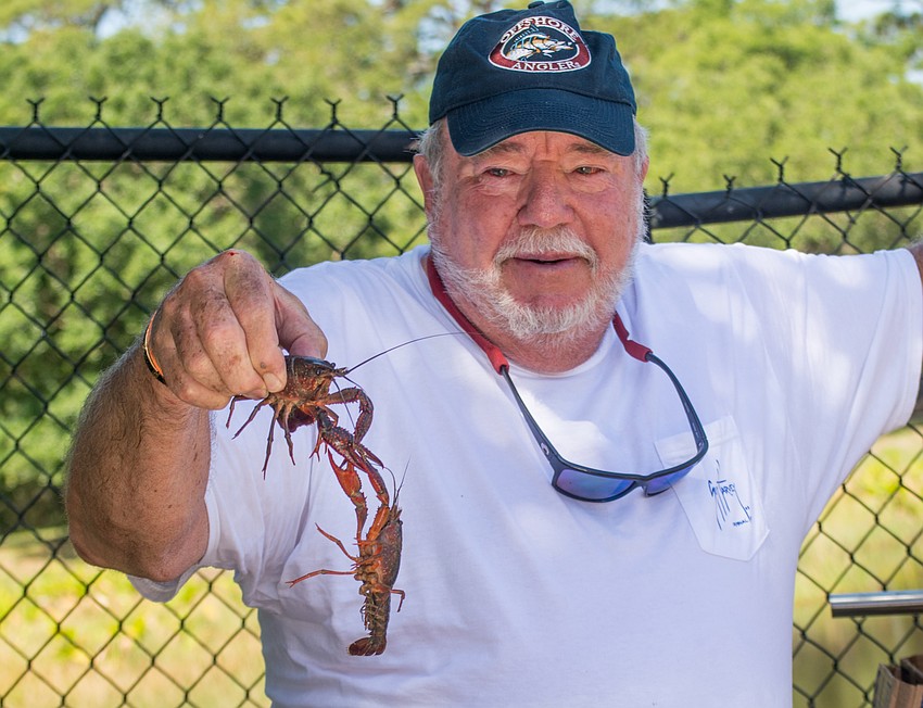 Jeff Workman picks up a crawfish.