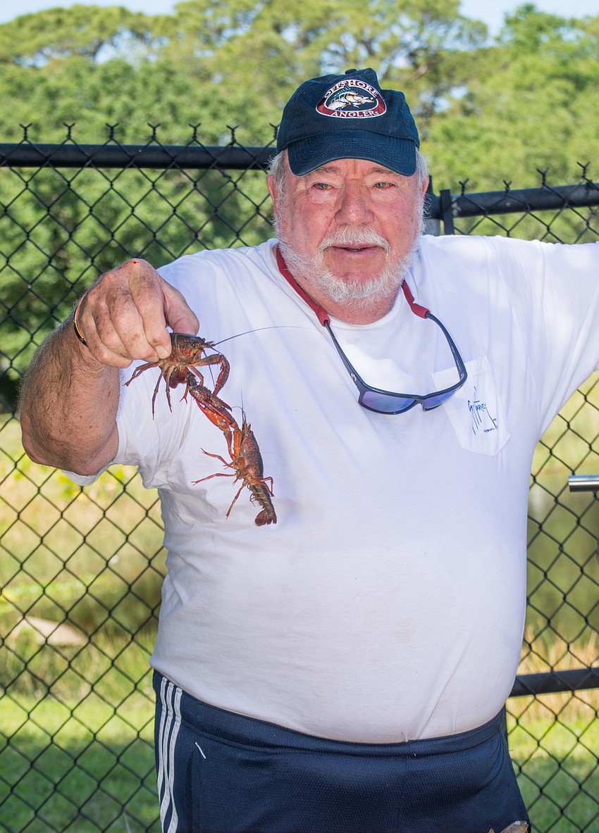 Jeff Workman picks up a crawfish.