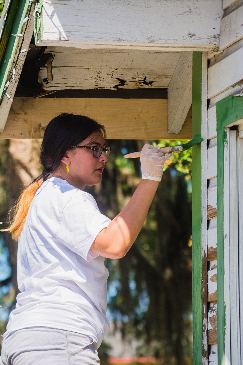 Asia Lorde paints the Wright Bush home.