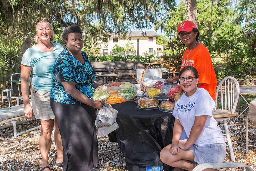 Pam Nolan, Valerie Buchand, Asia Lord and Vickie Oldham provide food for the volunteers.