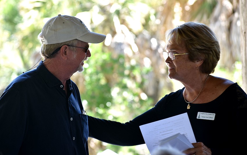 Grant Chairwoman Emmy Lou Gilbert presents Rusty Chinnis with a check for the Sarasota Bay Watch.