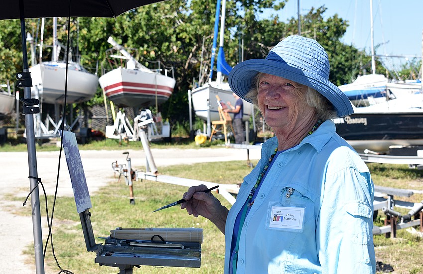 Diane Mannion smiles as she works on her painting.