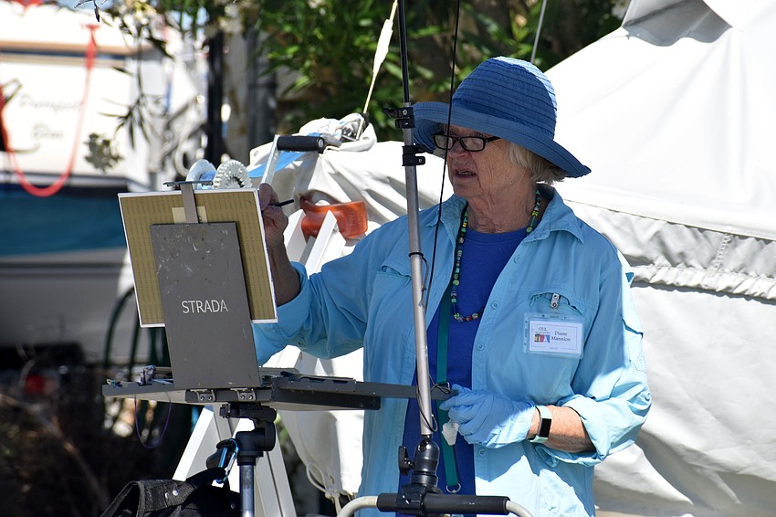 Diane Mannion focuses on her painting, which replicates a boat sitting on the Sarasota Sailing Squadron property.