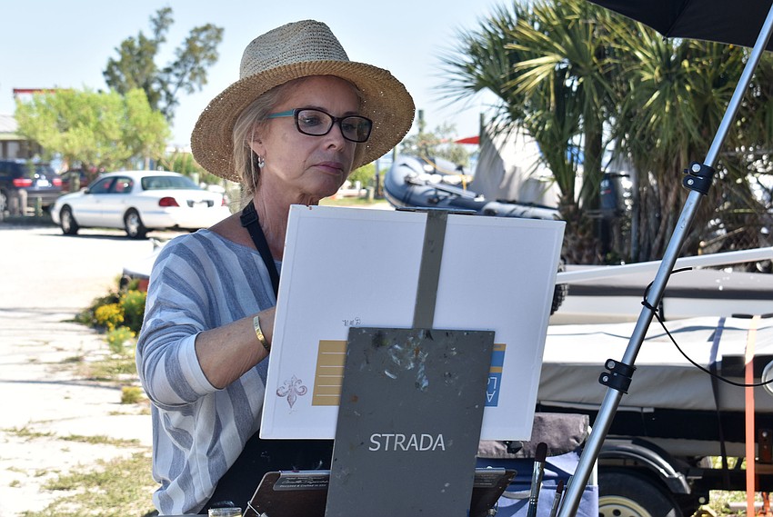 Linda Zentz works to complete her painting. She chose to paint a scene near the entrance of the Sarasota Sailing Squadron.