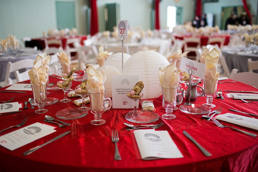 The Girls Inc. colors, red and white, filled the room.