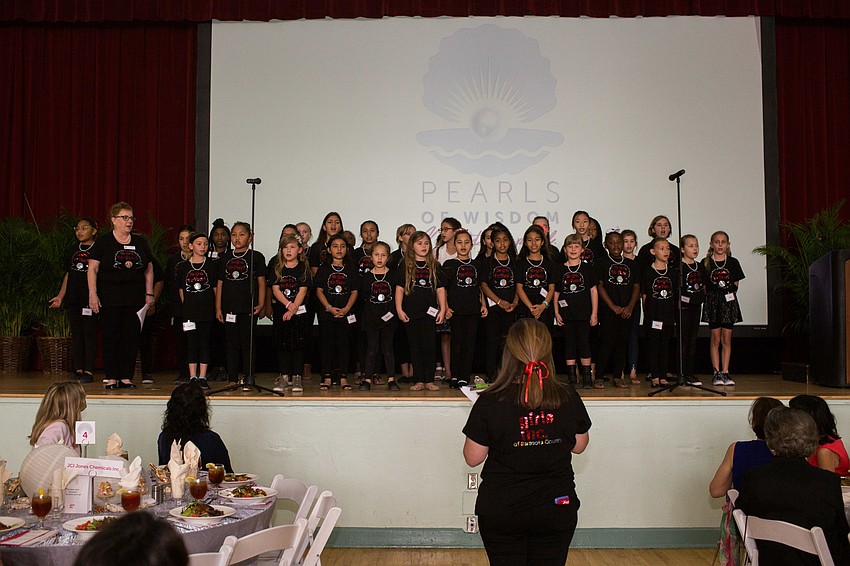 The Girls Inc. girls opened the luncheon up with a song.