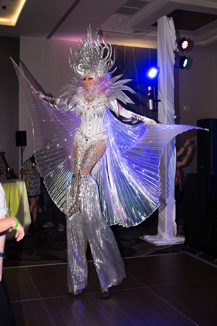 The dancer stood tall amongst the guests on the floor.