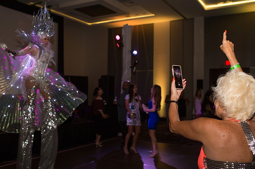 Guests took videos on their phone of the dancer on stilts.