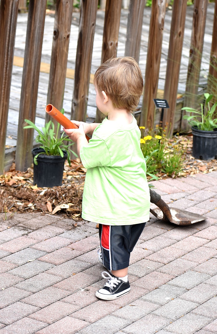 George Kozma tries to help dig a spot for a new plant.