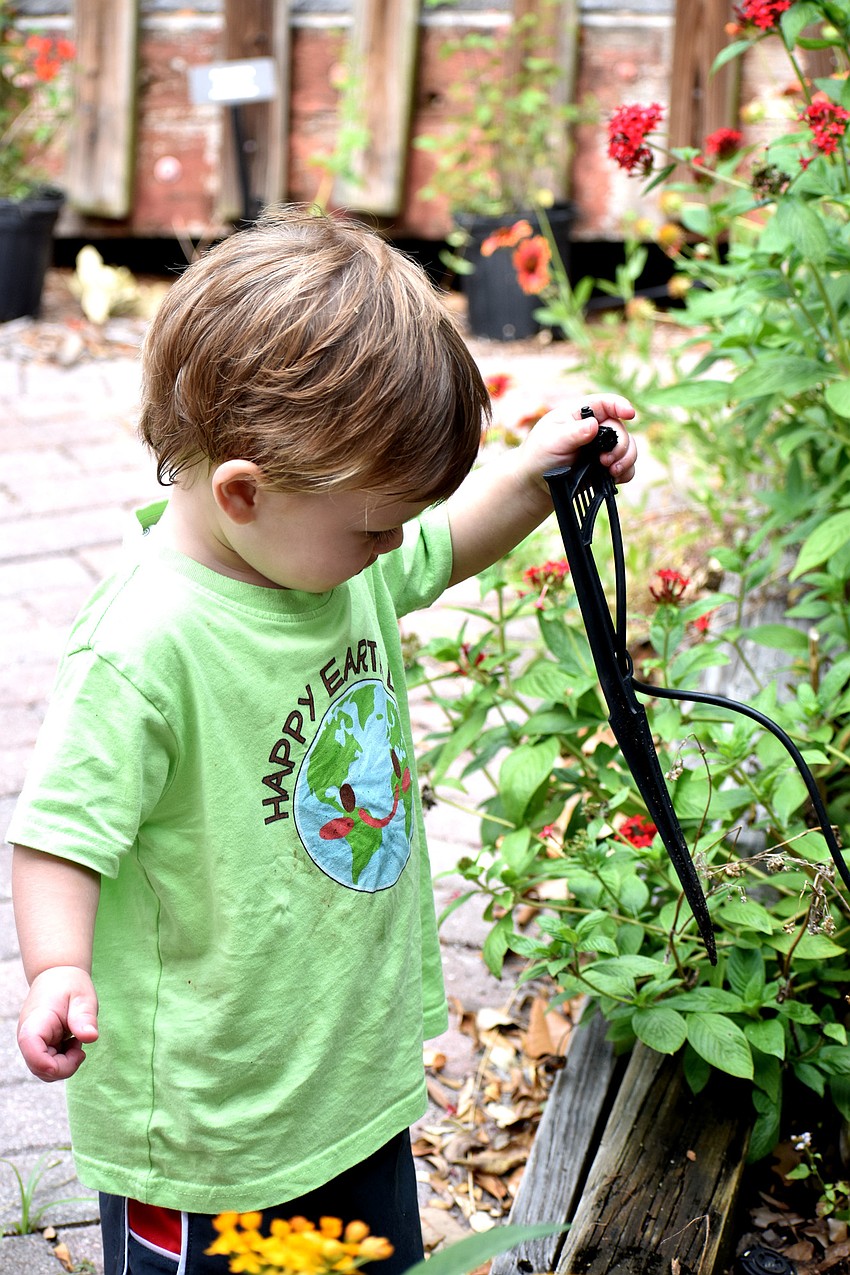 George Kozma inspects a sprinkler.