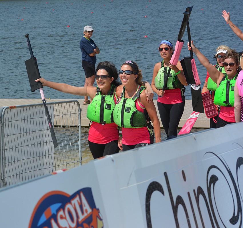 Joanne Hampton and Bambi Kaine lead their teammates off the dock after their victory in the finals.