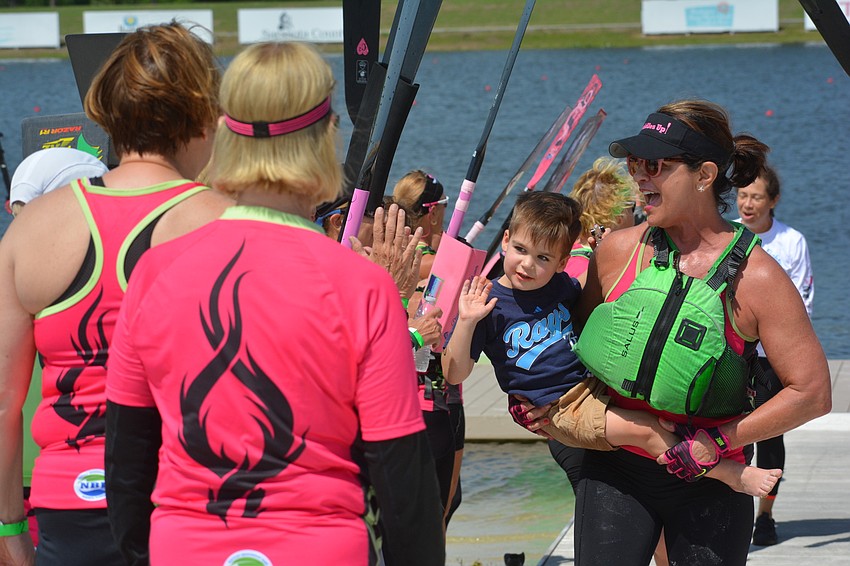 Lukas Krygowski and his grandmother, Carla Baldwin, celebrate with teammates after their victory.