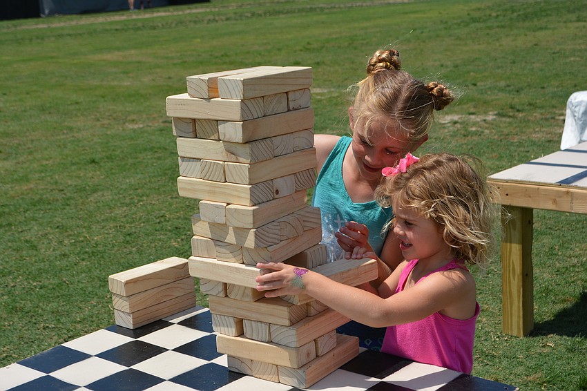 Lakewood Ranch's Mia McLauchlan, 7, and her 4-year-old sister, Molly, check out how many blocks they can pull before the tower falls.