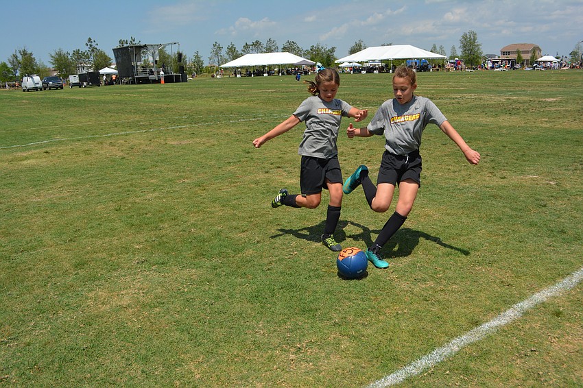 Madison Royer and Isse Flores, both 10-year-olds who play for the Lakewood Ranch Chargers, were demonstrating soccer at the event.