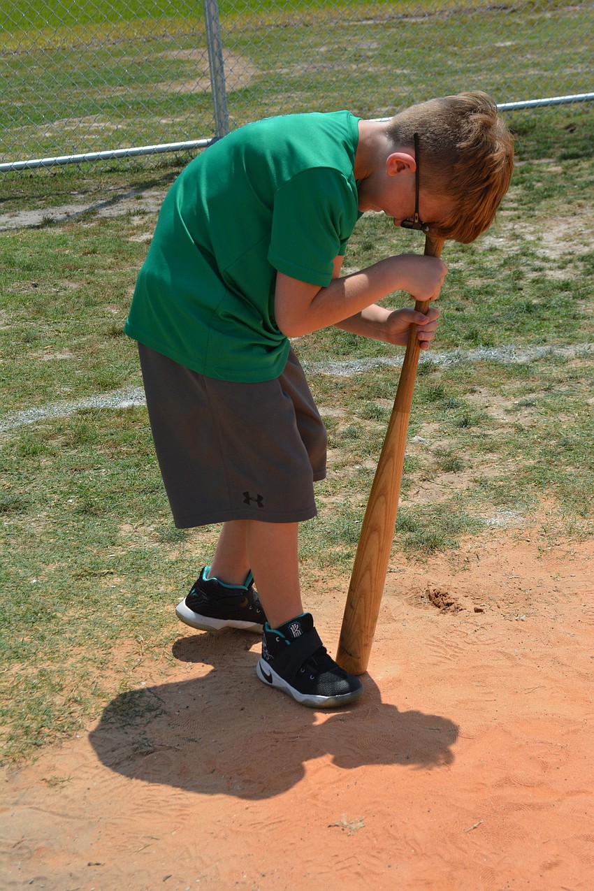 John Billiteri spins with his forehead on the end of the bat five times in dizzy bat, home run derby.