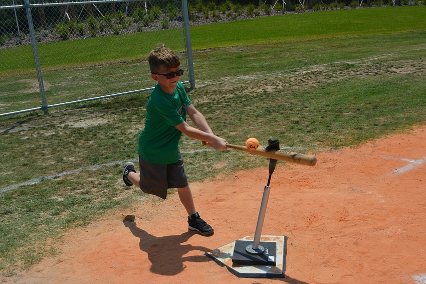 John Billiteri, 8, has a hard time connecting after spinning in the dizzy bat, home run derby contest.