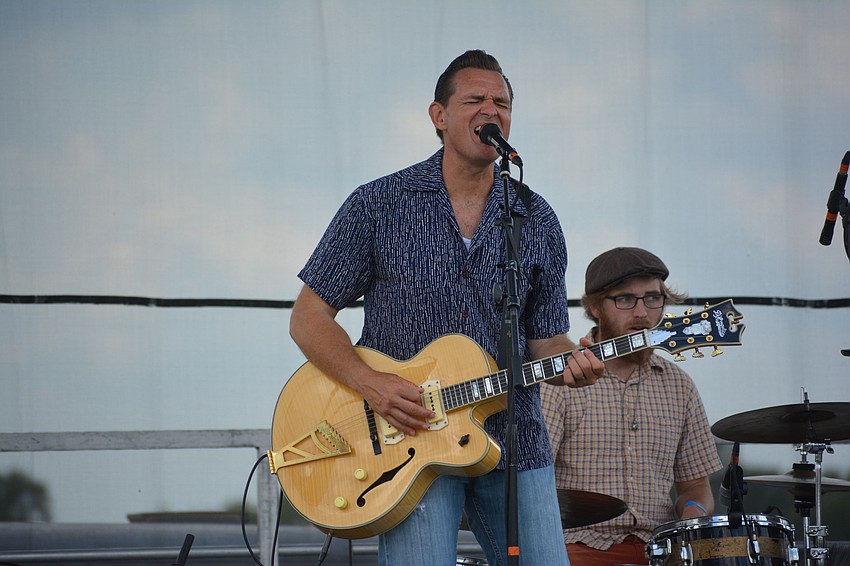 Doug Deming of the Jewel Tones belts out a tune for a crowd of fans who set up shop under two large canopies.