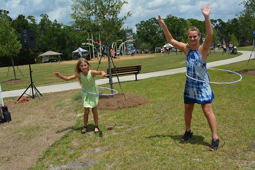 Bradenton's Payton Farah, 10, and her sister, Kailiana McDonald, 20, keep the hula hoop spinning. McDonald's boyfriend, Karim Manning, was the event DJ.