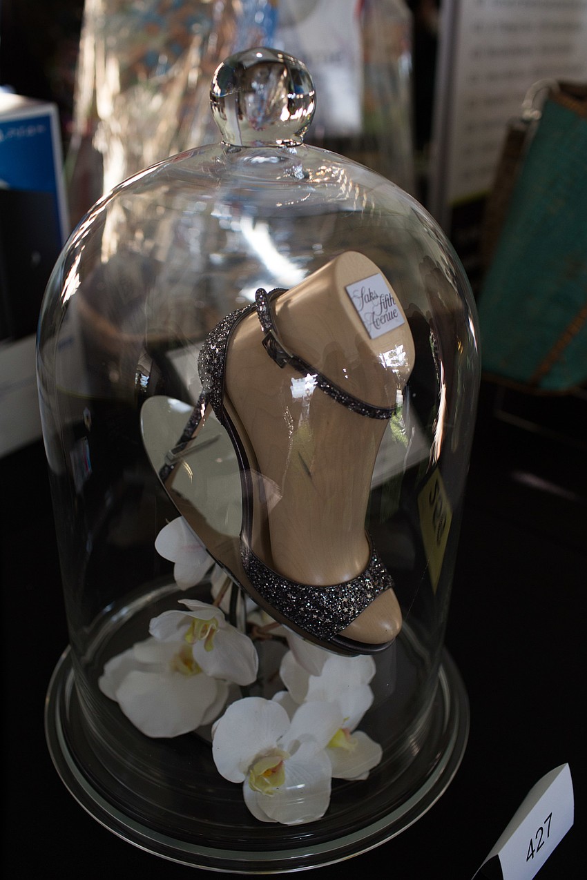 Silent auction items were displayed under the tent during cocktail hour.