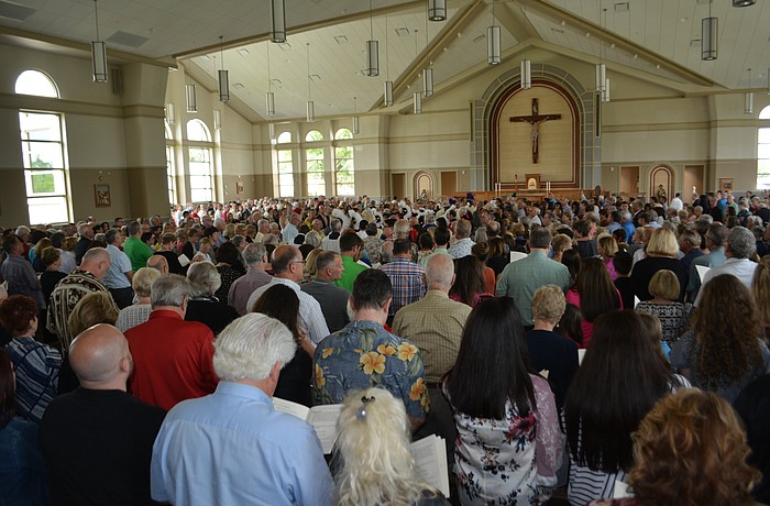 Parishioners pack the dedication of the Our Lady of the Angels Catholic Church on Sunday.