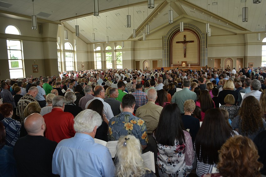 Parishioners pack the dedication of the Our Lady of the Angels Catholic Church on Sunday.