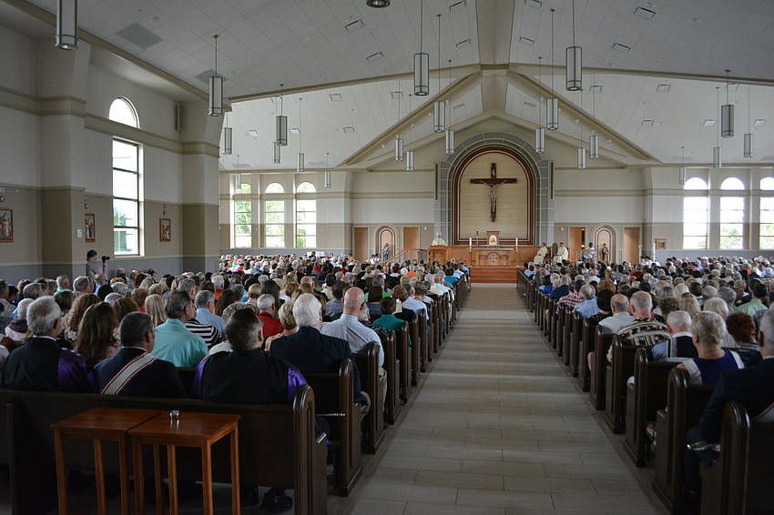 Rev. Frank Dewane, the bishop of the Diocese of Venice, tells the Our Lady of the Angels parishioners about the new church, 