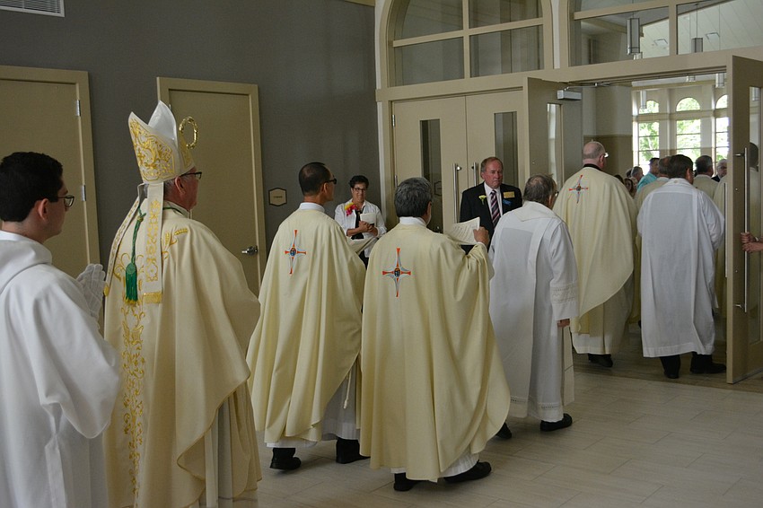 The clergy makes its way into the church for the service.