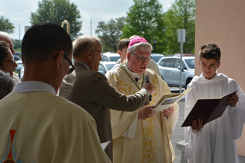 Rev. Frank Dewane, the bishop of the Diocese of Venice, blesses the new church before entering.