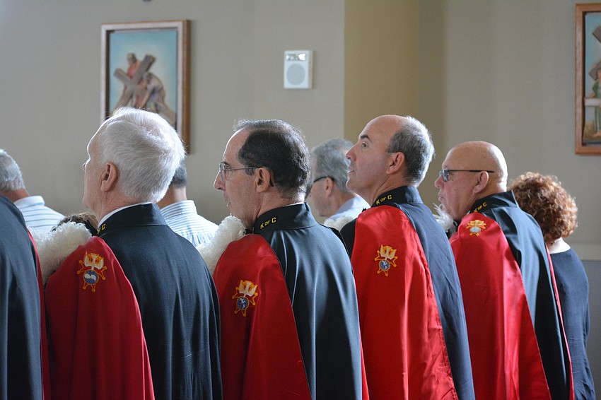 Members of the Knights of Columbus listen during the service.