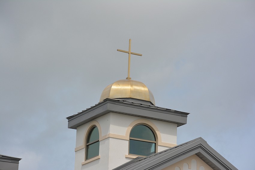 A cross sits atop of the new Our Lady of the Angels church in Lakewood Ranch.