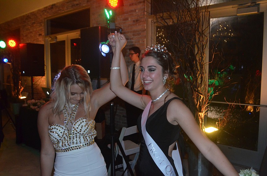 Seniors Gabby Alfonso and Sydney Hemming celebrate that Alfonso was named prom queen.