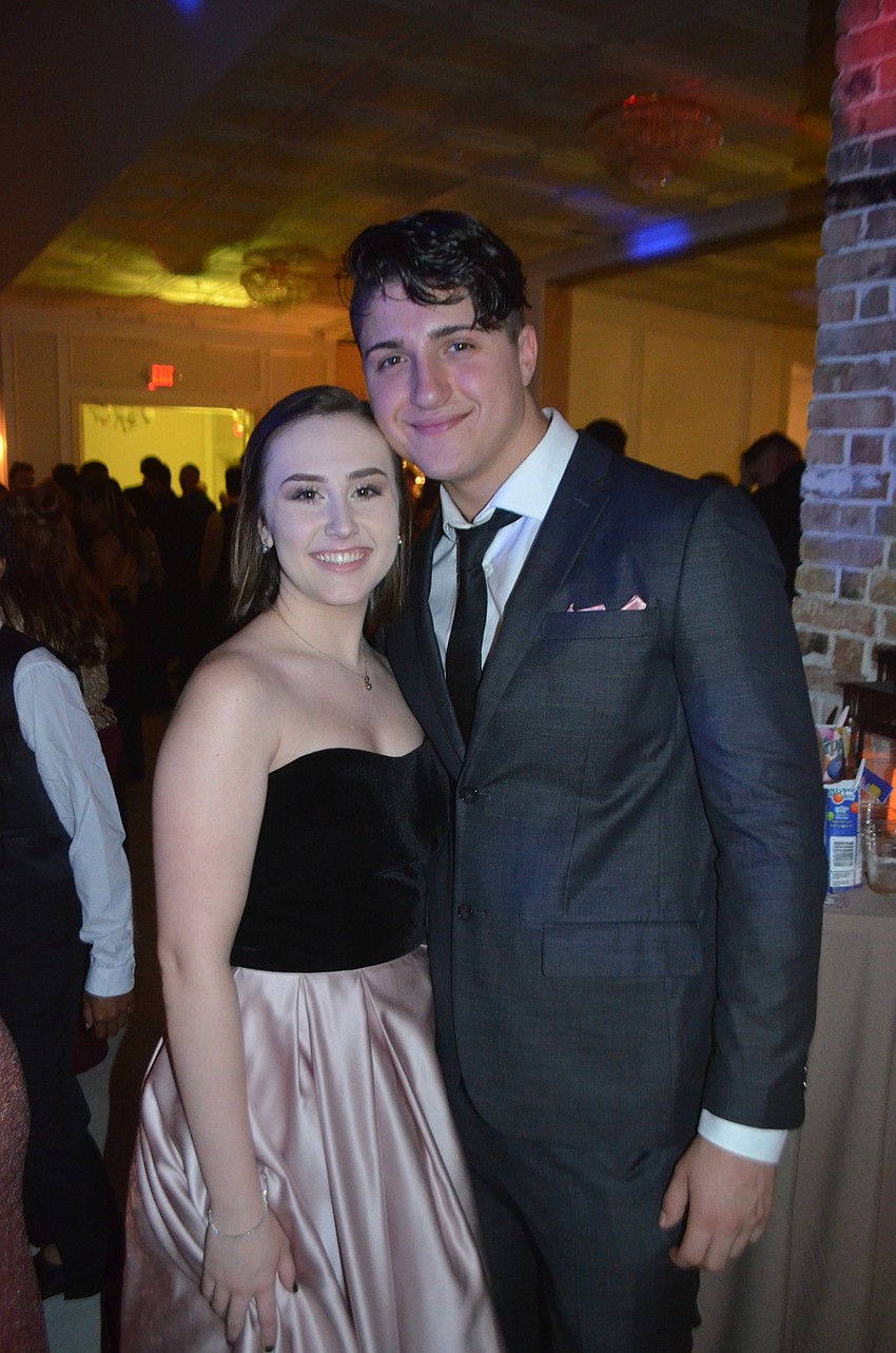 Seniors Brittany Dean and Andioni Giotiz are dressed for the occasion at the prom.