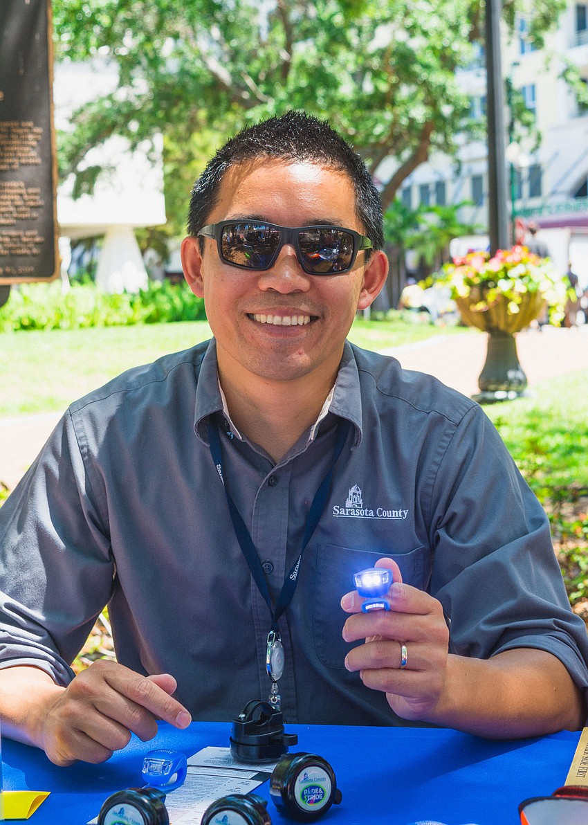 Patrick Lui gives away bike lights.