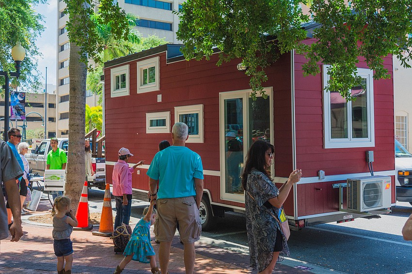 Visitors wait to tour to a tiny house.