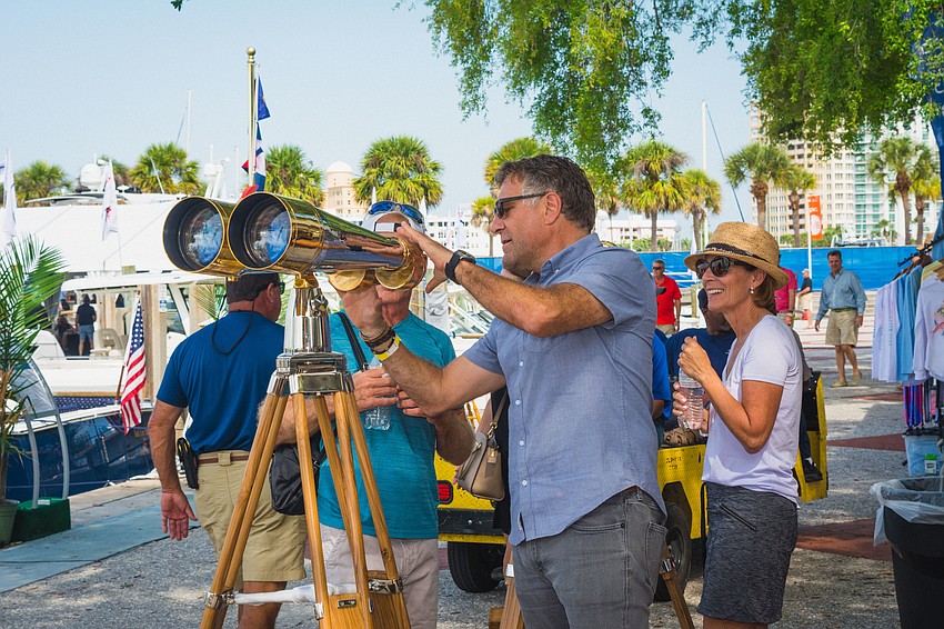 Gauro Coen show attendees how to use his vintage binoculars.