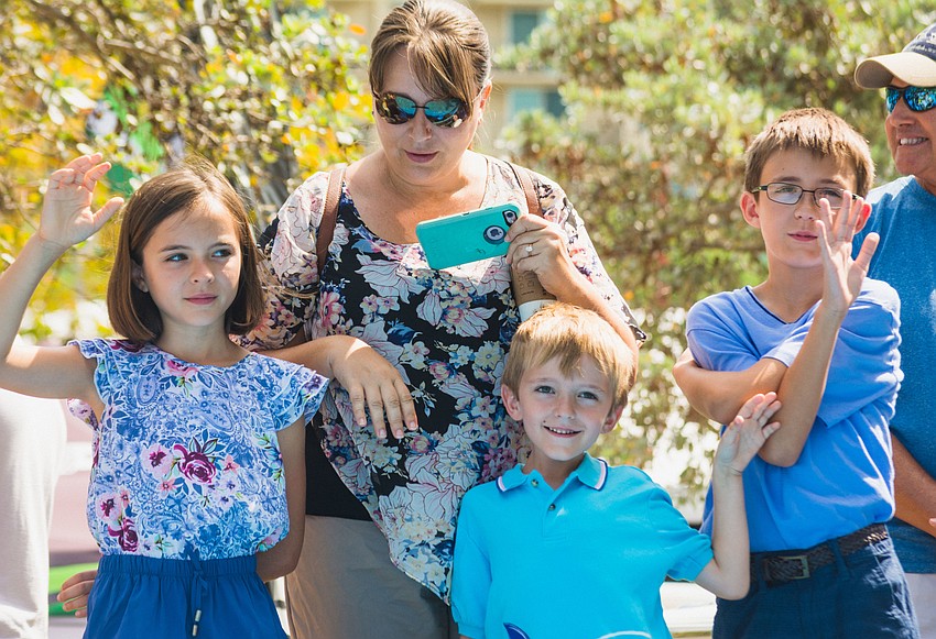 Katie, Andrew and Adam Lyda volunteer to help Twiggy the water skiing squirrel with her performance.