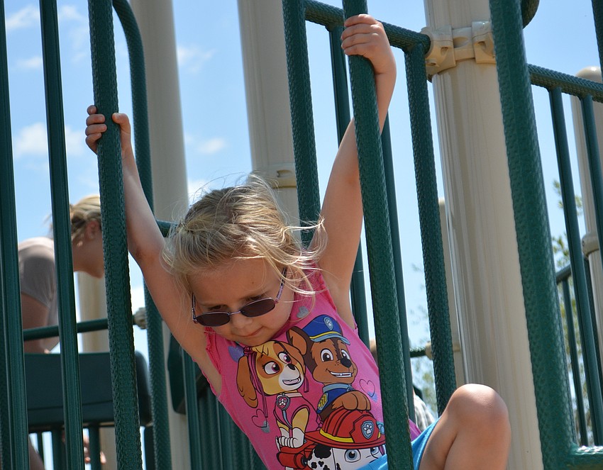 Lakewood Ranch's Brianna Natowski, 4, climbs to the top of the Tot Lot.