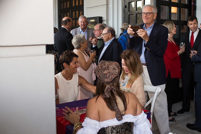 Harry Leopold takes a photo of Audrey Robbins getting her fortune told.