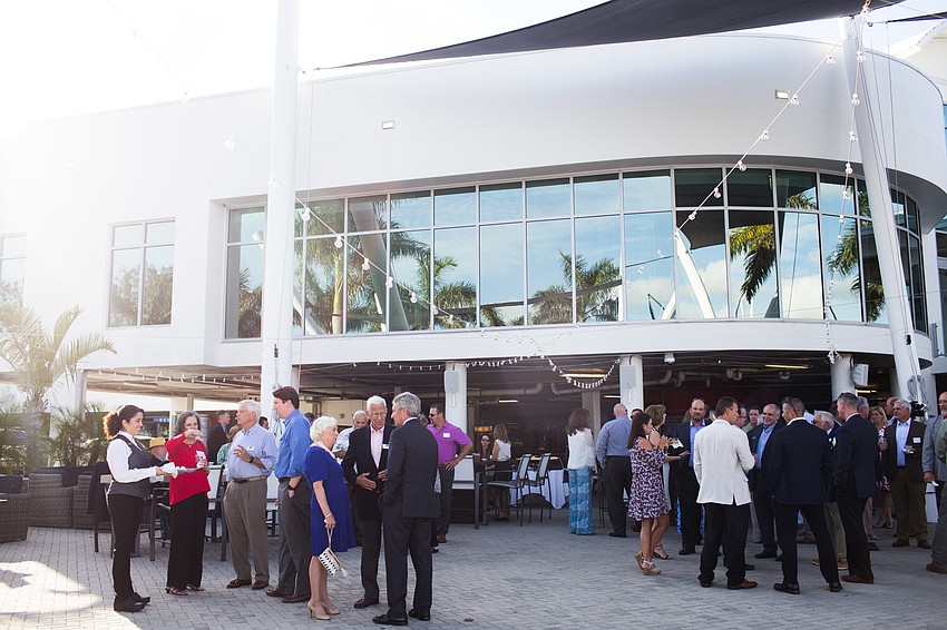 Guests socialized on the patio of the Sarasota Yacht Club.