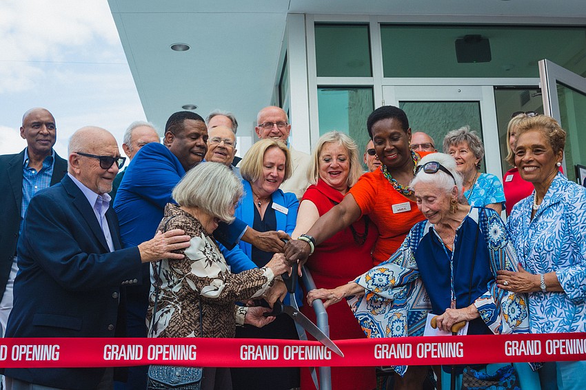 The ribbon-cutting ceremony marks the opening of the new building.